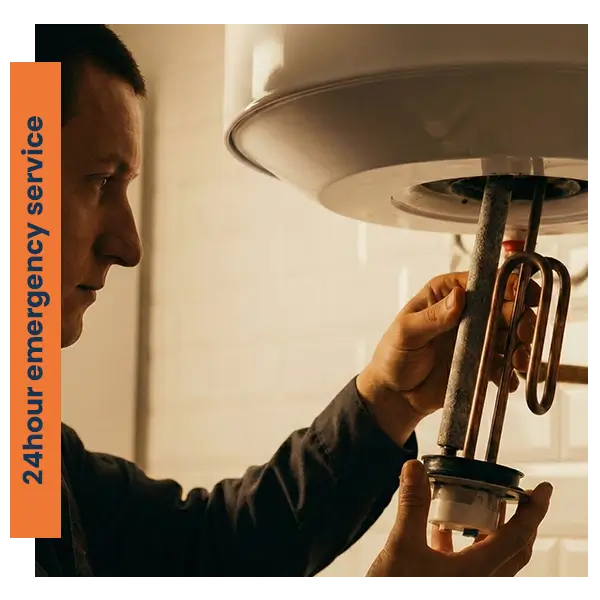 Close-up of a professional male technician replacing a heating element in an electric water heater tank.
